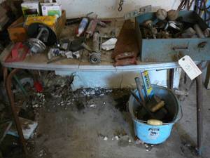 Table of Beer Tapper, Level, Handsaw, Bucket of Wheels
