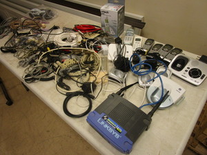 lot 377 image: LYNKSYS WIRELESS BROADBAND ROUTER, CORDLESS PHONES, PHONE CORDS, CABLE CORDS, ADAPTERS, MORE