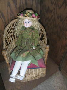 lot 16 image: Wicker Chair & Doll