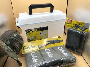 lot 19 image: Cabelas Ammo Box, 3 Gun Socks, Cap, Choke Tube Six