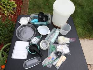 lot 132 image: Measuring Cups and Spoons, Digital Cooking thermometer, Pampered Chef Cutting board, (never opened), Tupperware, misc. items