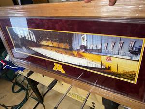 lot 83 image: Framed Original Minnesota Gophers Mariucci Arena with ghost picture of John Mayasich inserted into photo