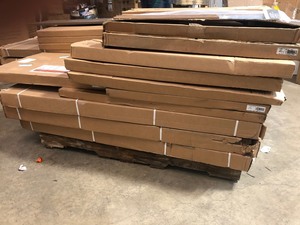 lot 51 image: Pallet with assorted Easy Track - closet kit parts- straight shelves, corner shelves various colors and sizes not used