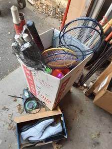 lot 38 image: Box Of Sporting Goods-Golf Ball Return & Shoes, Badminton Net & Raquets, Inflatable, Bubbles, Toys & More