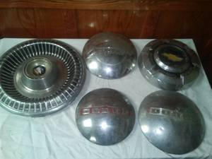 lot 107 image: 5 Hubcaps -2 Dodge, 1- Plymouth, Chevy and Buick All pretty nice.