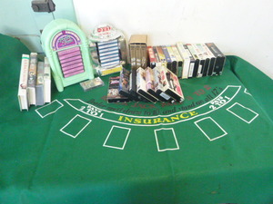 lot 56 image: VHS Movies, Cassettes and Poker Mat