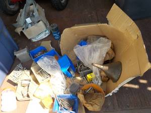 lot of bolts, metal hardware, and m...