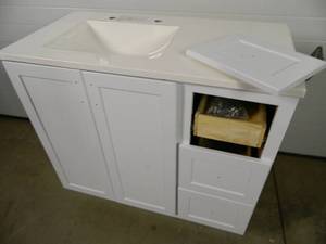 lot 31 image: Bathroom Vanity with Top and Sink (needs repair)