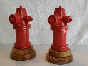 lot 84 image: (2) Red Cast Iron Fire Hydrants on Wooden bases