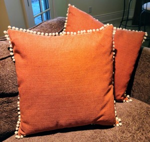 lot 8 image: Burnt Orange With White Poms Down Filled Accent Pillows