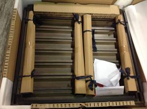 lot 104 image: Jasper Ridge Farmhouse Black Frame Rectangular Metal Outdoor Patio Dining Table with Wood Grain Tabletop by Hampton Bay not used whit small damage on the table stock photo used to display the unit