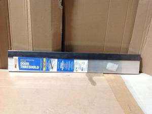 lot 48 image: Frost King EO 5-58 in. x 3 ft. Silver& Brown Fixed Sill Threshold &nbspin good condition
