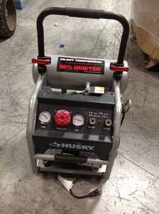 lot 104 image: Husky 4.5 Gal. Portable Electric-Powered Silent Air Compressor in working conditions