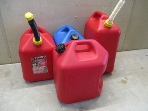 lot 75 image: Three Red 5 Gallon Gas Cans and One 5 Gallon Blue Kerosene Can