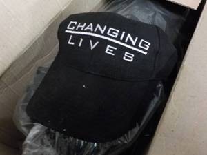 lot 203 image: Box of 24 Changing Lives Hats...