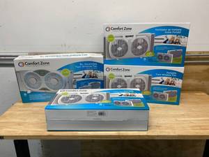 lot 78 image: COMFORT ZONE Lot of Three- 9 in. Twin Window Fans with Reversible Airflow Control, Auto-Locking Expanders and 2-Speed Fan Switch in White  One- 9 in. 3-Speed Expandable Reversible Twin Window Fan with Remote Control and Removable Cover and Bug Screen