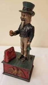 lot 49 image: Vintage Cast Iron Figural Banks  Uncle Sam and Mammy
