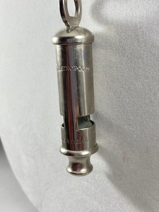 lot 26 image: Vintage The Metropolitan Whistle Necklace- Made in England