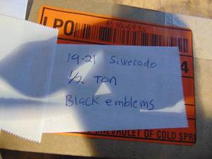 lot 189 image: Black Chevy Emblems