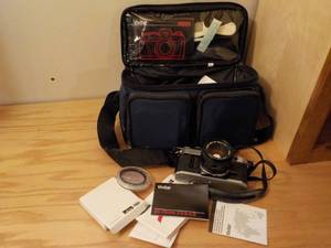 lot 590 image: Canon AE-1 35mm film camera with accessories, camera bag