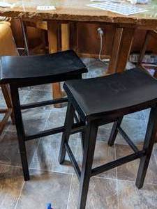 lot 424 image: 2 TALL WOODEN SADDLE STOOLS
