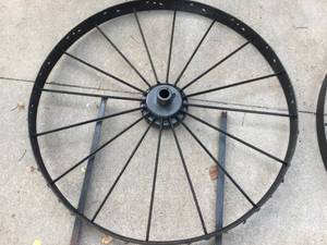 lot 185 image: Two Large Steel Wheels With Ground Mounting Stakes Welded To Them