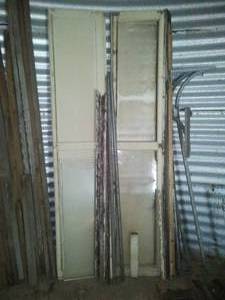 Garage door - wood panels,  has rails, 11 foot tall x 9 foot wide