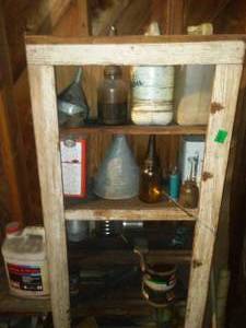 Cabinet with contents. Old glass Oil Bottles.