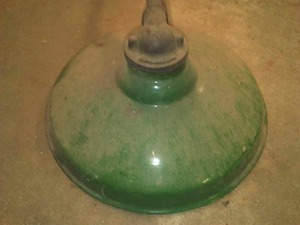 Vintage green enamel light fixture on pole.