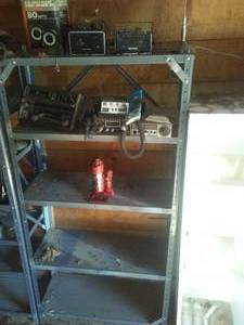 lot 50 image: Shelf and Contents, 3 ton Jack, CB Radios stereo and more.