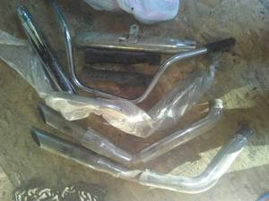 lot 51 image: Misc. Haley Davidson PartsAccessories. Exhaust, 2 Handlebars - one new