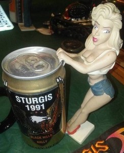 lot 232 image: Sturgis Rally Beer Girl and more. Mugs, skull cap.