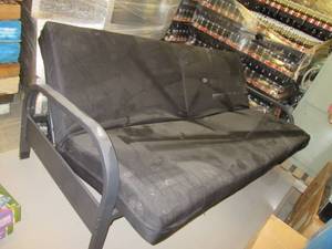 lot 503 image: Futon Couch, metal frame.  Looks new except for dust from storage