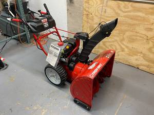 lot 90 image: TROY-BILT Storm 28 in. 243cc Two-Stage Electric Start Gas Snow Blower with Heated Grips and Airless Tires