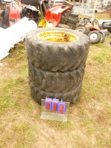 lot 9 image: Qty of 3 Skid loader tires. 2 are 1050-16.5 gel filled. 1 has cut on tread. Very heavy. Good 6 hole rims. As shown.