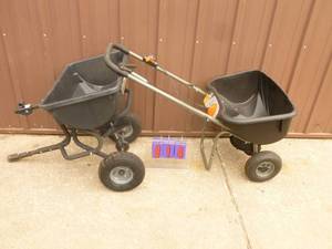 lot 14 image: Qty of 2 fertilizer spreaders. Appear new. One needs wheel. As shown.
