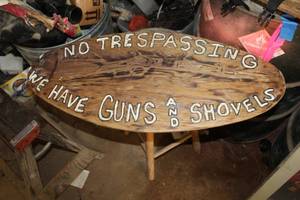 lot 308 image: No Trespassing We Have Guns and Shovels Wood Wall Art