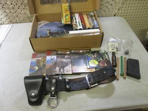 lot 40 image: Gun Belt Hunting DVDs VHS and Othe...