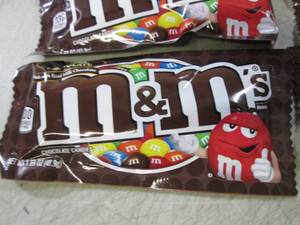 lot 72 image: 12 Bags of M&Ms Best by Aug 2020  ...