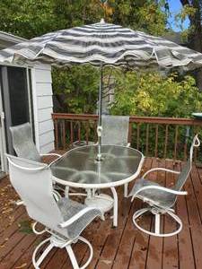 lot 233 image: Patio Table, Four Chairs, And An Umbrella