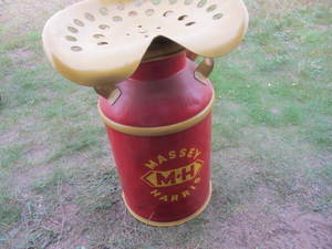 lot 86 image: Tractor Seat on Milk Can