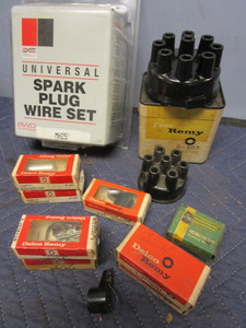 lot 766 image: ASSRTD. IGNITION PARTS, DELCO-REMY BRAND, CONDENSERS, BRUSHES, CAPS, WIRE PLUG SET, MORE