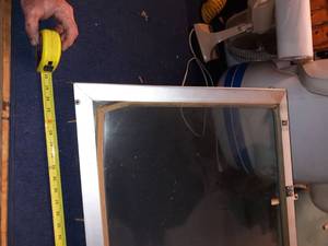 lot 74 image: Older glass windshield off of a Larson.