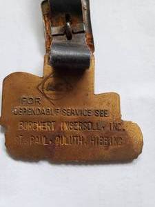 lot 28 image: Allis Chalmers Watch Fob from the Iron range