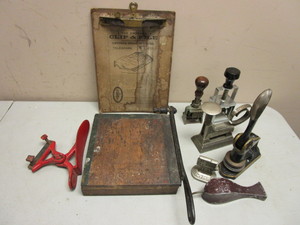 lot 142 image: ANTIQUE OFFICE TOOLS, PAPER CUTTER, EMERSON CLIPFILE CLIPBOARD, STAMPERS, SHOE SHINE FORM, MORE