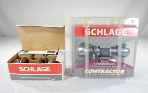 lot 99 image: Lot of 2 New Schlage Commercial Storeroom and Classroom Keyed Locking Satin Chrome Door Knob Sets
