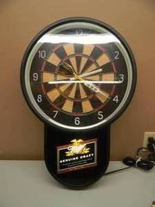 lot 99 image: NEW IN THE BOX - MILLER GENUINE DRAFT LIGHTED DART BOARD CLOCK - WORKS - SEE PICTURES