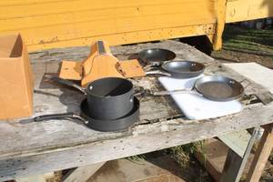lot 497 image: Lot of (8) Cooking Pans (6), Cutting Board (1), Kiwi Shoe Groomer Box (1)