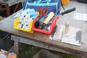 lot 667 image: Caulk Cartridges (x12), Plastic Storage Bins (x2), Drywall Blades (x3), Paint Roller, Misc. Tools