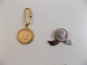 lot 106 image: Half Dollar Knife With 1973 Kennedy 12 $, 1974 12 Kennedy Coin & Holder